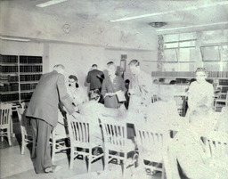 Summer Registration 1961: Group of People Around Table Registering