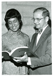 John X. Jamrich and Woman Looking at Northern Michigan University Bulletin (Part of the NMU Historic Photographs Collection)