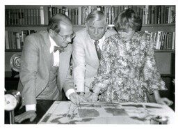 John X. Jamrich and Two Unknown People Looking at Drawings (Part of the NMU Historic Photographs Collection)