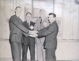 Alumni Activities Summer 1960: Four Men Standing Posed With Hands Together