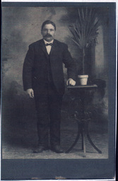 Portrait of Man with Mustache and Plant