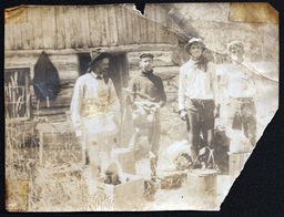 Four Men Outside Log Cabin