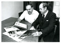 Two Men Looking at Plaque and Books (Part of the NMU Historic Photographs Collection)