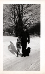 Man with Snowshoes and Dog