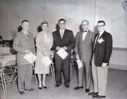 Alumni Activities Summer 1960: Four Men, One Woman Standing With Papers