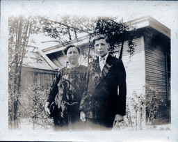 Mother and Son in Front of House