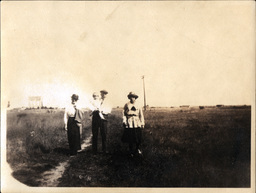 Three Adults and Child in Field