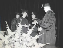 Summer Commencement 1960: Man and Woman About To Shake Hands On Stage