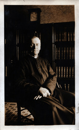 Priest Posing with Books