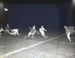 Intrasquad Football Game Spring Practice--Outstanding Back: Mike Strebel, Outstanding Lineman: Wayne Sickler 1961: Player Attempting to Tackle