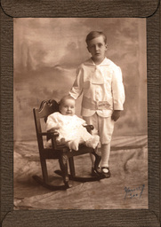 Studio Portrait of Boy and Baby in Chair