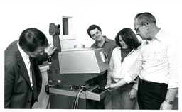 Group of People Looking at Machine (Part of the NMU Historic Photographs Collection)