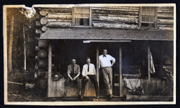 Three Men on Porch of Log House