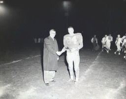 Intrasquad Football Game Spring Practice--Outstanding Back: Mike Strebel, Outstanding Lineman: Wayne Sickler 1961: Man Shaking Hands With #84