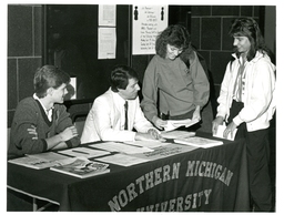 Students Talking to Man behind General Assistance Table (Part of the NMU Historic Photographs Collection)