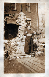 Priest Standing near Rock Opening