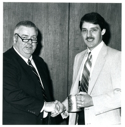 Man Holding Stein and Shaking Hand of Another Man (Part of the NMU Historic Photographs Collection)