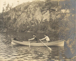 Teal Lake shoreline with men in rowboat