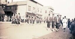 (005-003) Shriners Walking Past F.J. Lyons Drug Company (1 of 2)