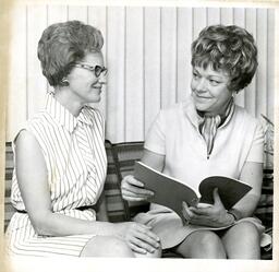 Two Women Pose with Open Book (Part of the NMU Historic Photographs Collection)