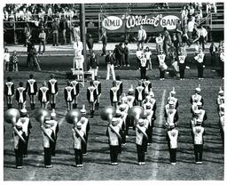 Marching Band Performing in front of NMU Wildcat Band Sign (Part of the NMU Historic Photographs Collection)