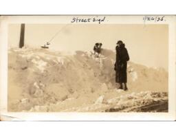 Woman and Small Dog on Snow Bank