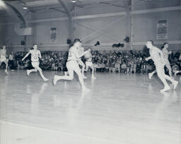 (128-02) Basketball NMC vs. Michigan Tech Feb. 24, 1960: Northern Player Dribbling