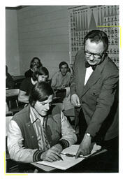 Professor Pointing to Something on Student’s Paper (Part of the NMU Historic Photographs Collection)