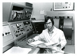 Student with Binder and Large Electronic Machine (Part of the NMU Historic Photographs Collection)