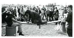 Student Crossing Makeshift Bridge on Hands and Knees (Part of the NMU Historic Photographs Collection)