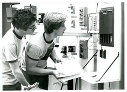 Two Students Looking at Electronic Equipment (Part of the NMU Historic Photographs Collection)