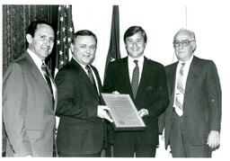 James Appleberry, Michigan Governor James Blanchard, and Two Unknown Men Posing with Plaque (Part of the NMU Historic Photographs Collection)