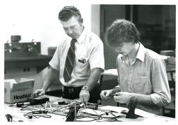 Professor and Student Working with Electronics Kit (Part of the NMU Historic Photographs Collection)