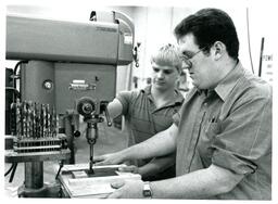 Two Students Operating Drill with Jig (Part of the NMU Historic Photographs Collection)