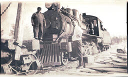 Two Men Stand by Locomotive