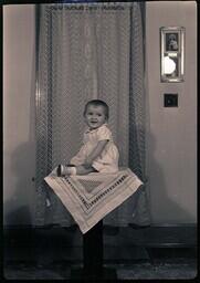 (166-009) Child Sitting on Table