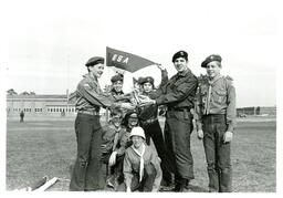 Man in Military Uniform Handing Trophy to Boy Scout Troop (Part of the NMU Historic Photographs Collection)