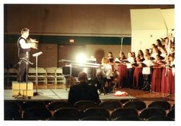 Side View of Man Directing a Choir in an Empty Gymnasium (Part of the NMU Historic Photographs Collection)