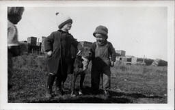 Two Children Holding Dog's Collar