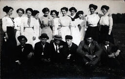 Women Standing and Men Sitting in Group Photo