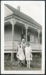 Three People Outside House