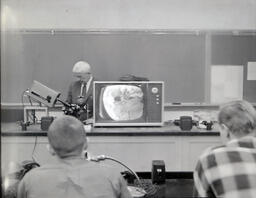 Closed Circuit T.V.--Dr. W. James Merry and Embyology Class 1961: Professor Showing Class Something Under Microscope on TV