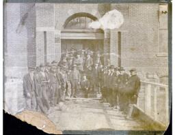 Job Dowd in Group Photo with Large Building