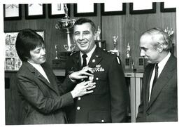 Uniformed Man Getting Medal from Man and Woman (Part of the NMU Historic Photographs Collection)