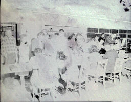 Summer Registration 1961: Larger Group of People Around Table Registering